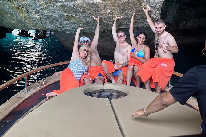 All-Inclusive Capri Boat Tour with City Visit from Positano - Early coastline stops: Spiaggia Grande and Roman-era Bagni di Tiberio