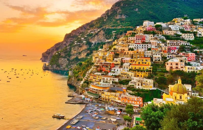 Positano stacked up the cliff above the sea at golden hour