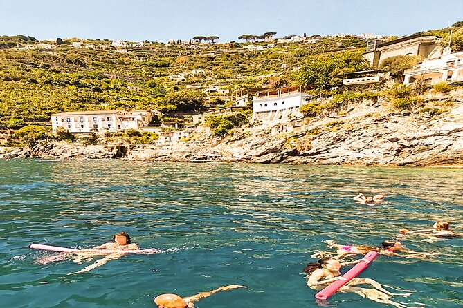 From Amalfi: Coast & Furore Fjord Boat Tour with Swim Break - The onboard experience: crew, music, and an easier pace